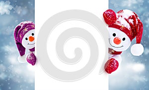 Little snowmen in caps and scarfs on winter background. Background with a funny snowmen. Christmas card.