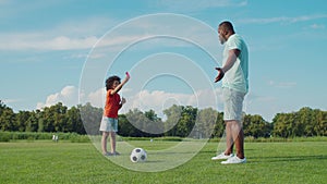 Little soccer referee showing red card to dad in park