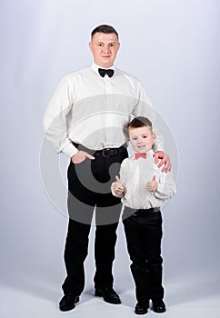 Little son following fathers example of noble man. Gentleman upbringing. Father and son formal clothes outfit. Formal