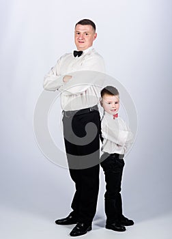 Little son following fathers example of noble man. Gentleman upbringing. Father and son formal clothes outfit. Grow up