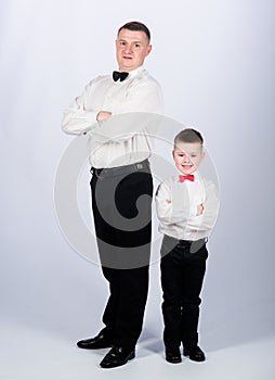 Little son following fathers example of noble man. Gentleman upbringing. Father and son formal clothes outfit. Grow up