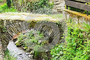 Little stone bridge over a stream in the park Bacharach, Germany