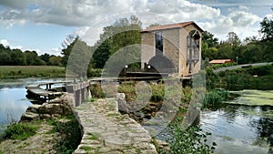 Little stone bridge on river