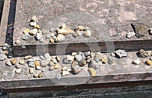 Little stones on the tombstone in the jewish cemetery