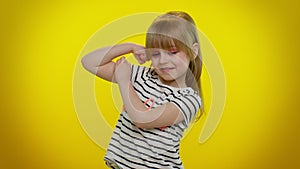 Little strong kid child girl showing biceps and feeling power strength, energy to gain success win