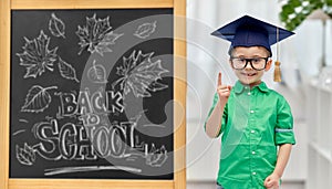 little student boy in bachelor hat and eyeglasses