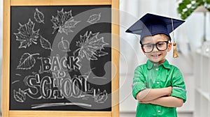 little student boy in bachelor hat or mortarboard