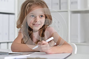 little student girl making homework