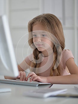 little student girl making homework