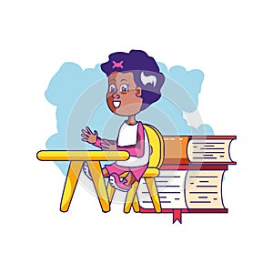 little student girl sitting in school desk with stack books