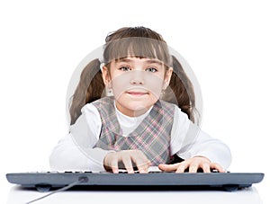 Little student girl typing keyboard. isolated on white background