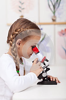 Little student study plants in biology class