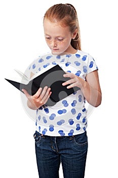 Little studious girl reading a book