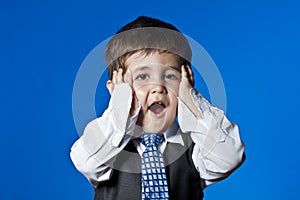 Little surprised businessman, cute little boy portrait over blue