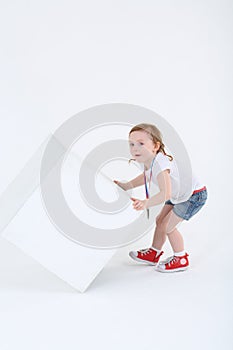 Little surprised girl with medal on chest reverses cube