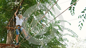 A little sweet girl, in a climbing adventure park.The safe of extreme sports