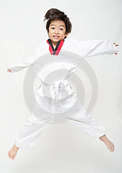 Little tae kwon do boy martial art jumping photo