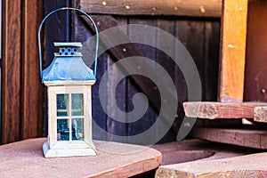 Little tealight lantern on wooden boards outside