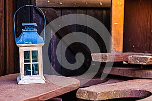 Little tealight lantern on wooden boards outside