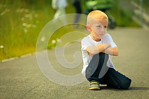 Little thoughtful boy child portrait outdoor