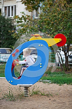 Little three year old boy playing on the playground