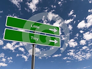 Little - Tiny traffic sign on blue sky photo