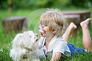 Little toddler baby boy, child with painted face as a dog, playing with pet dog in the garden