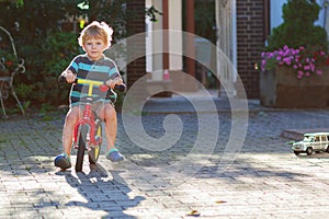 Little toddler boy of 3 years having fun on his bicycle