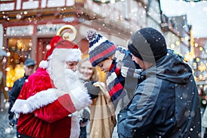 Little toddler boy with father and Santa Claus on