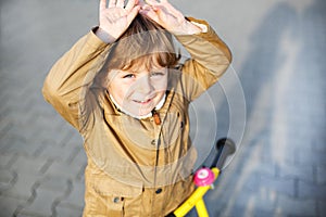 Little toddler boy having fun and riding his bike