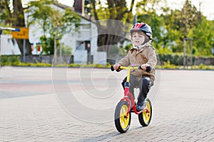 Little toddler boy having fun and riding his bike