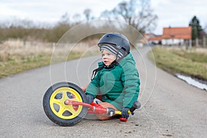 Little toddler boy sad about his broken bicycle