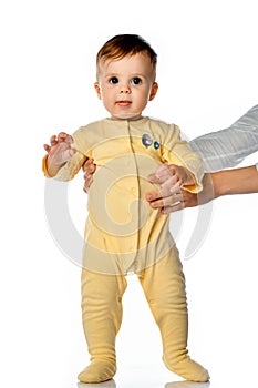 Little toddler child learning to walk studio portrait