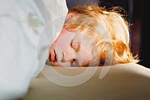 Little toddler child resting on say in parents bed. Adorable kid boy sleeping and dreaming. Peaceful and relaxed rest