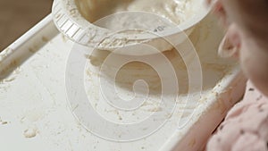 Little toddler girl eating porridge.