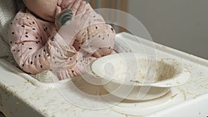 Little toddler girl eating porridge.