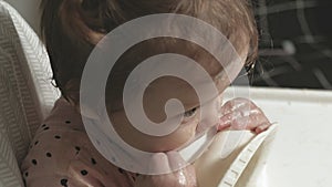 Little toddler girl eating porridge.