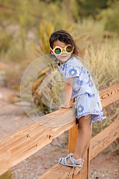 Little toddler girl enjoying summer at nature in the park, childhood memories and lifestile portrait concept