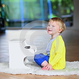 Little toddler girl plays toy piano