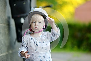 Little toddler girl ready to ride a bike