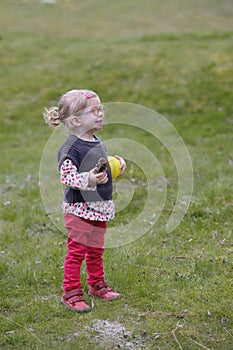 Little toddler with glasses in the garden