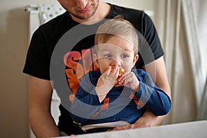 Little toddler held by his father