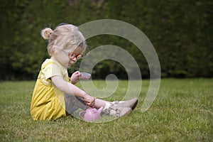 Little toddler playing tea time outdoors