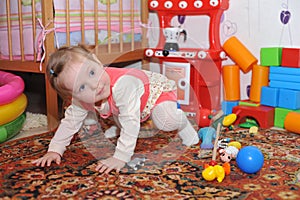 Little todler baby girl having fun indoor the room