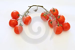 Little tomatoes on white background