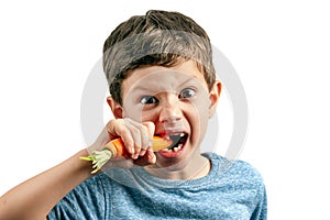 A little toothless boy was biting a carrot