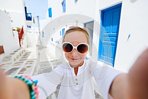 Little tourist girl taking selfie in Greece