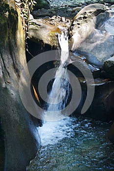 Little tranquil waterfall among the rocks of mountain creek