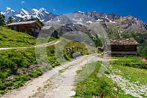 Little Triftalp village with the preserved old wooden farmhouses and majestic Mischabel massif and Dom peak behind