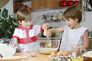 Little Twin Brothers Making a Cream For Homemade Cake in Glass Bowl